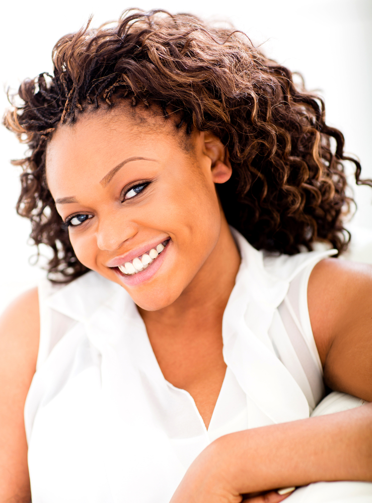 Happy black woman relaxing at home and smiling